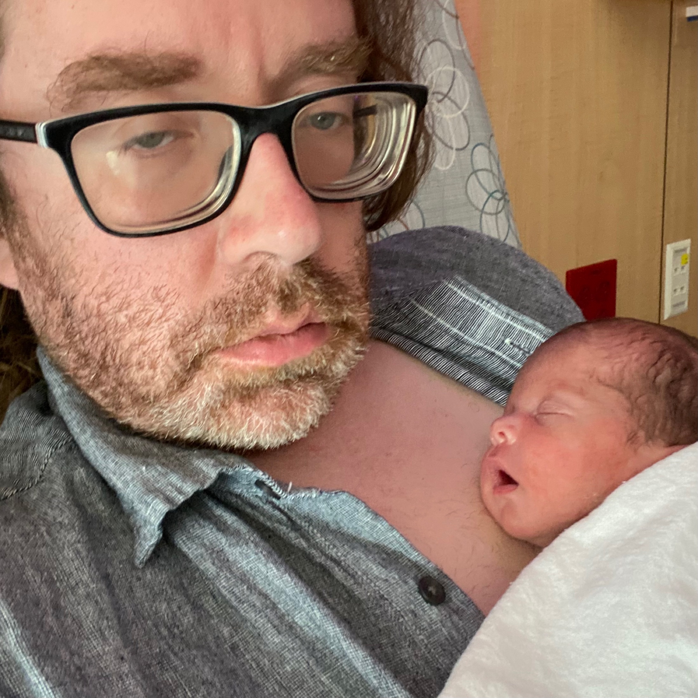 Dad doing skin-to-skin kangaroo care with baby in the NICU